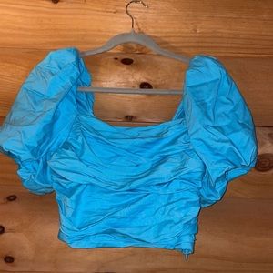 Bright blue cropped top.